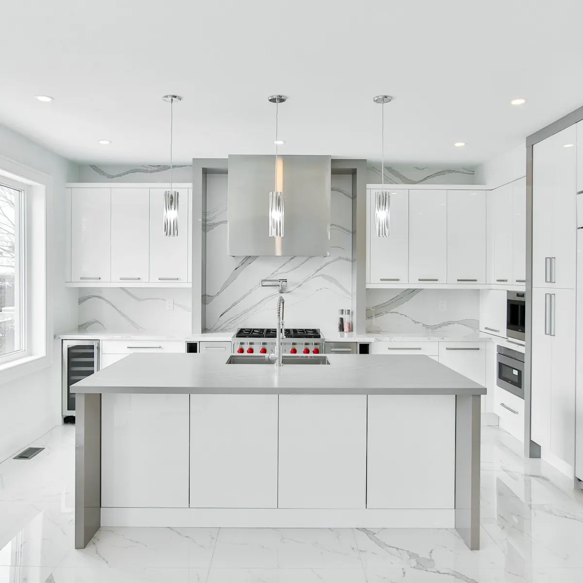 Modern white kitchen with quartz countertops and a center island