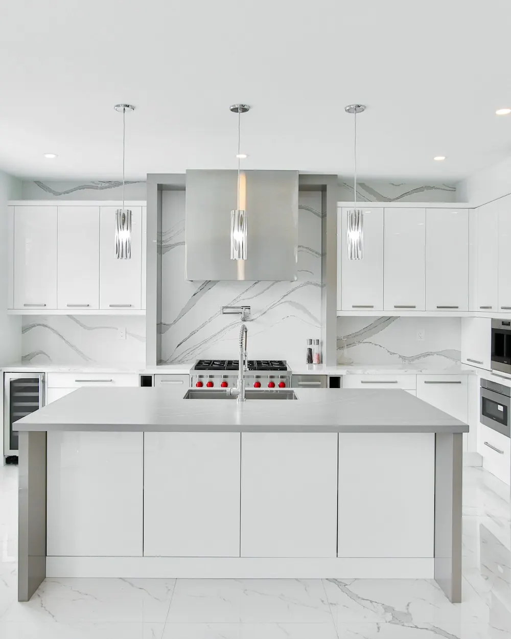 Modern white kitchen with quartz countertops and a center island