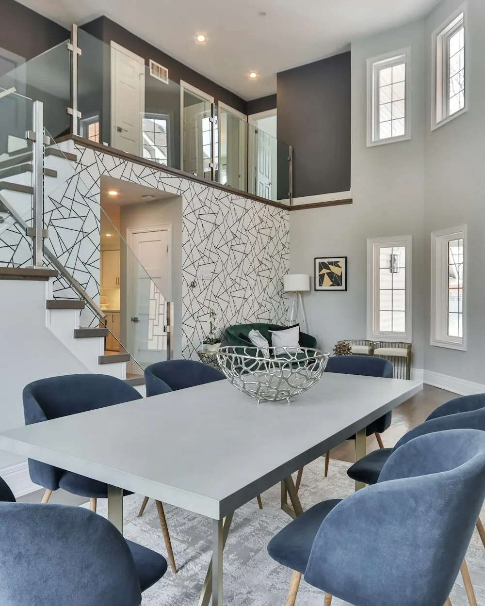 Renovated dining area next to a glass-railed staircase
