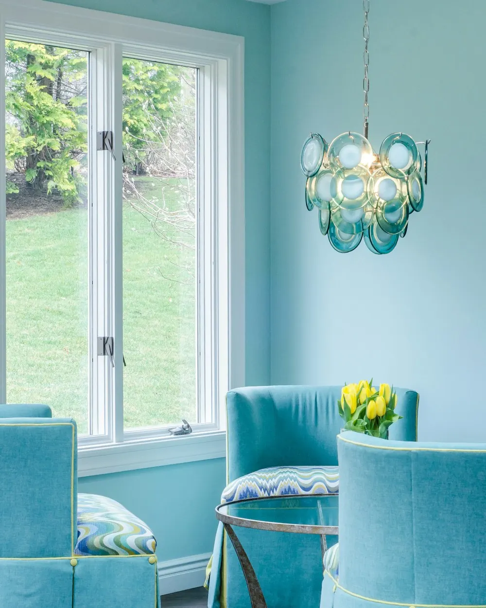 Sitting room freshly painted in turquoise with matching chairs